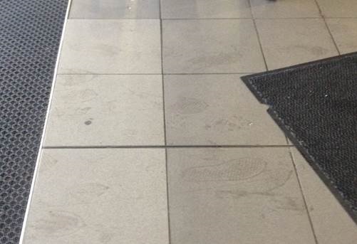 Wet footprints after recessed entrance mat